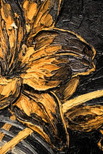 Close-up of a textured painting with gold and black colors